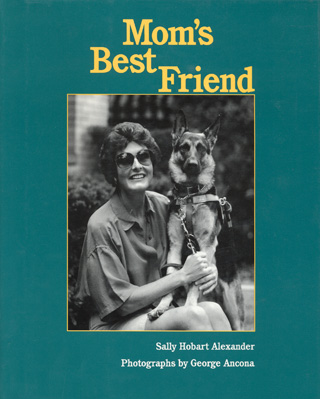 This black and white Cover shows a photo of me on one knee with guide dog Ursula close.