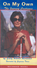 This cover shows a color photo of me in a red top, standing with her cane, looking out at the world, quizzically.